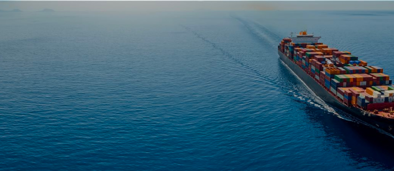 Ship carrying containers in the middle of blue sea water.