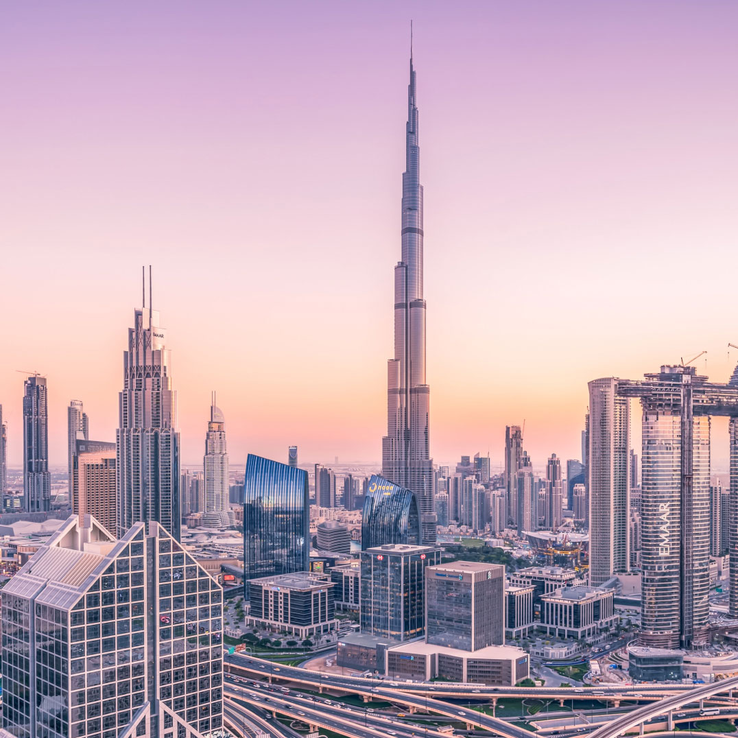 Burj Khalifa in pink background and a scenic view of the city.